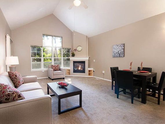 A spacious living room with a cozy fireplace and dining area.