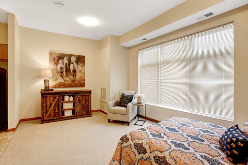 A cozy and well-decorated bedroom featuring a serene color palette and tasteful artwork.