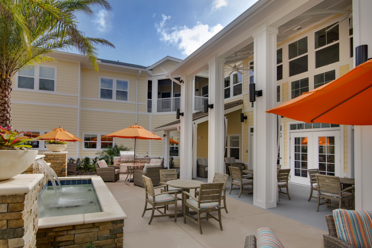 Spacious outdoor patio area with seating and umbrellas.