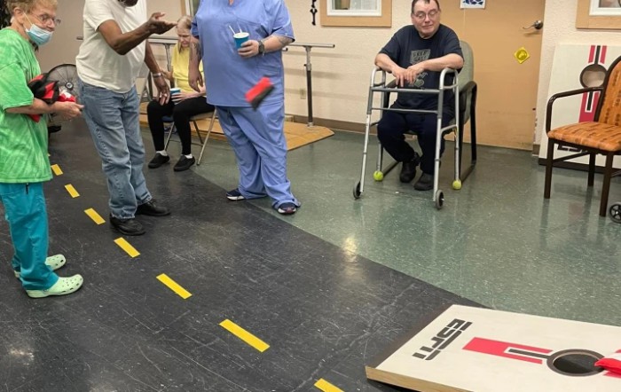A group of people enjoying an indoor game activity in a communal setting.