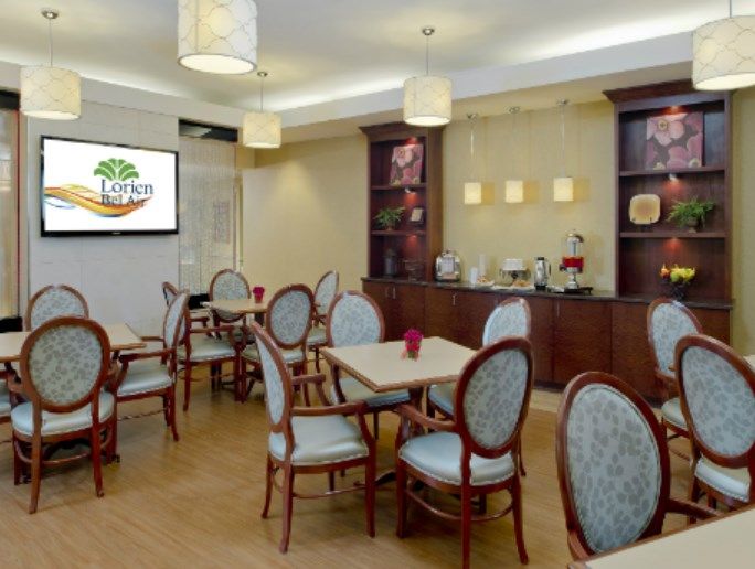 An elegant indoor dining area with neatly arranged tables and chairs.