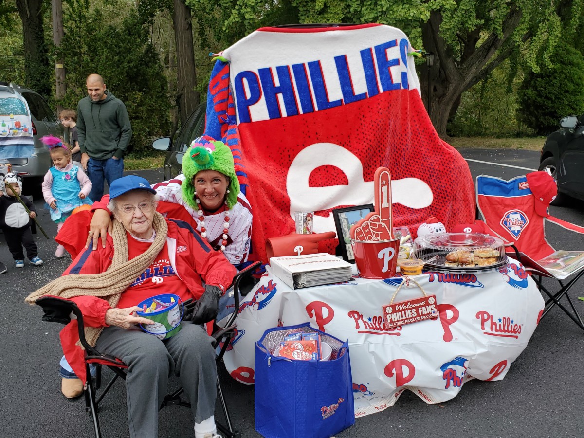 Philadelphia Phillies fans enjoying a tailgate with themed merchandise and decorations.