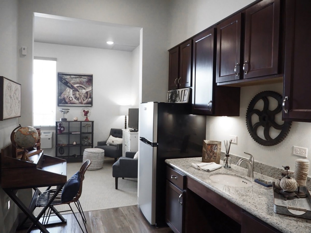 A modern apartment featuring a compact kitchen and cozy living area.