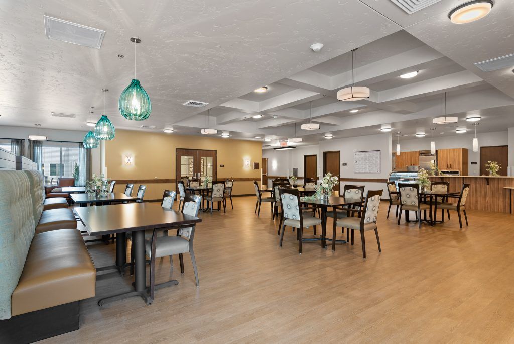 A spacious and modern dining area with stylish lighting and well-arranged furniture.