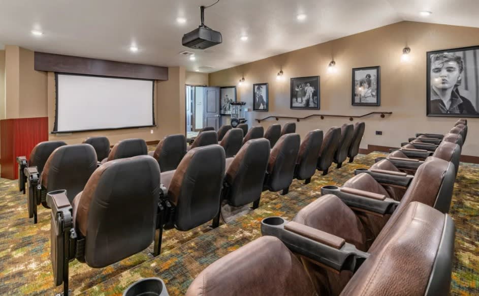 A modern home theater with comfortable seating and a large projection screen.