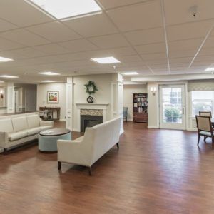 A spacious and well-lit living room with comfortable seating and elegant decor.
