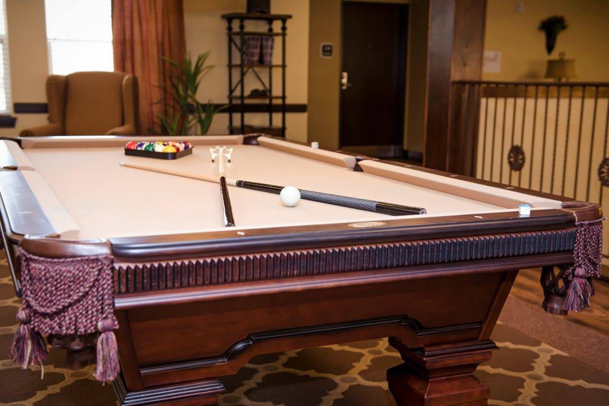 A pool table set up for a game in a cozy indoor setting.