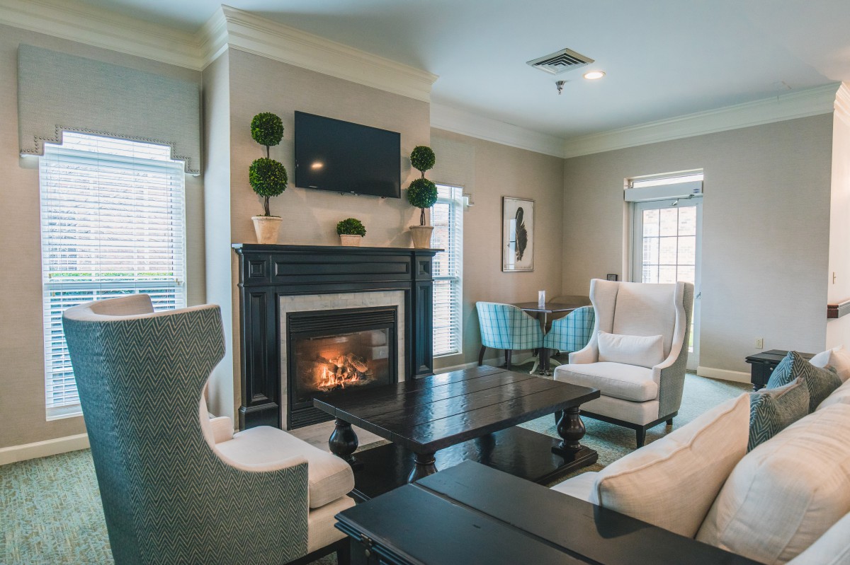 A cozy living room with elegant furniture and a warm fireplace.