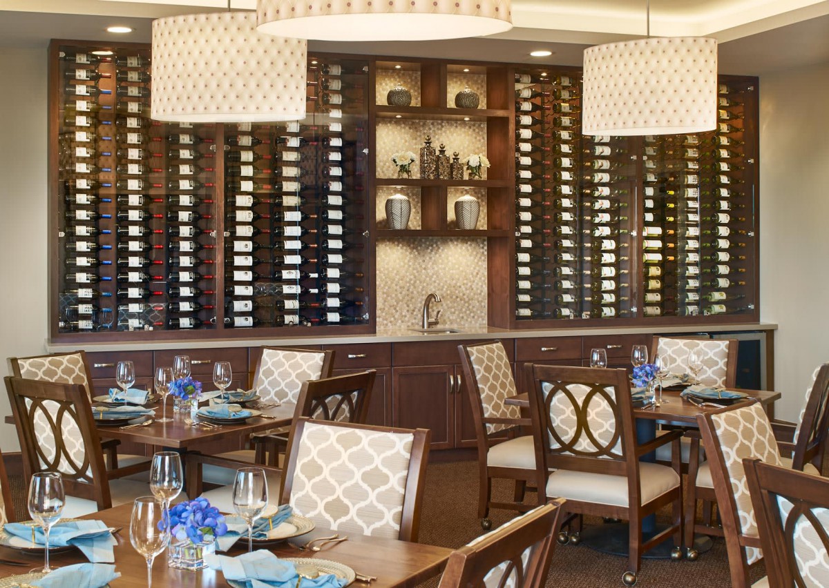 Elegant restaurant dining area with wine racks and stylish interior.