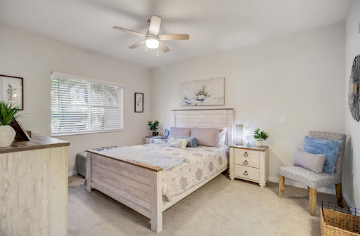 A serene and modern bedroom featuring a comfortable bed, stylish furniture, and a calming color palette.