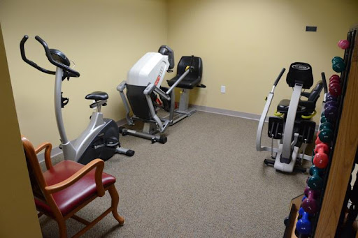 A small gym area equipped with exercise bikes and an elliptical machine.