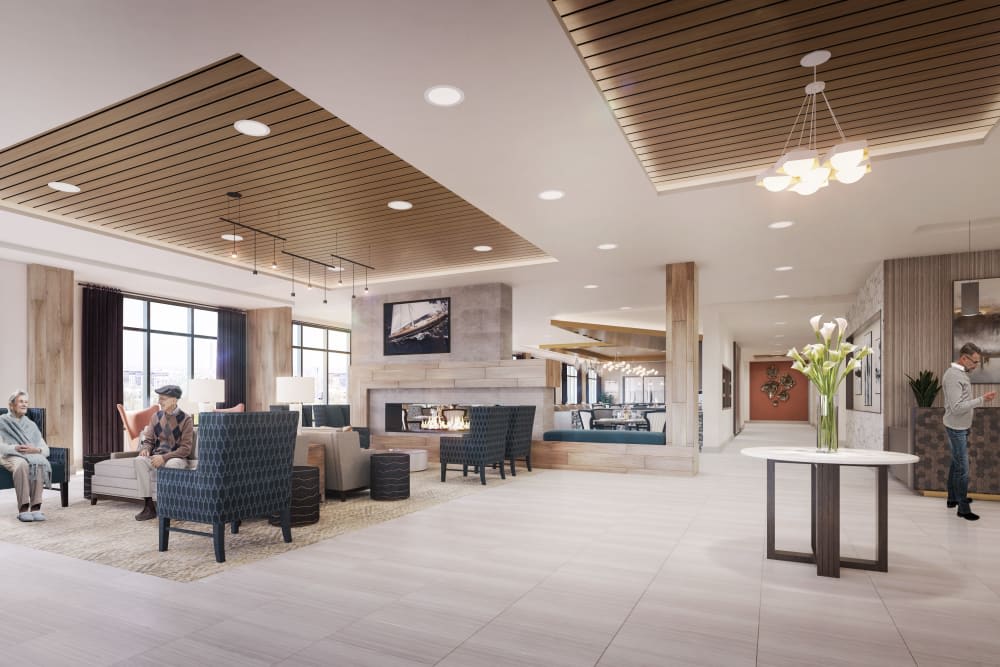 A spacious and elegantly designed modern lobby with comfortable seating and a fireplace.