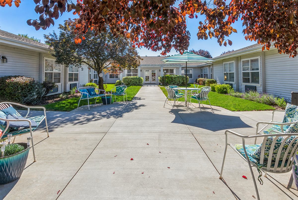 A sunny courtyard with outdoor seating and a well-maintained garden.
