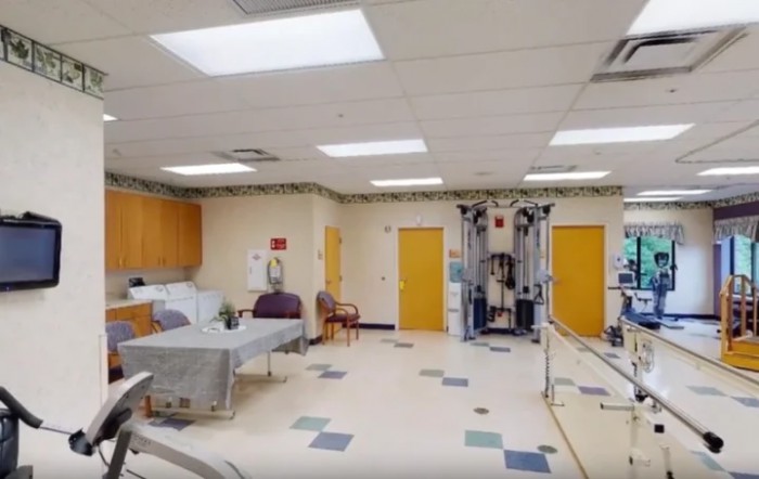 A hospital rehabilitation room with medical equipment and therapy facilities.