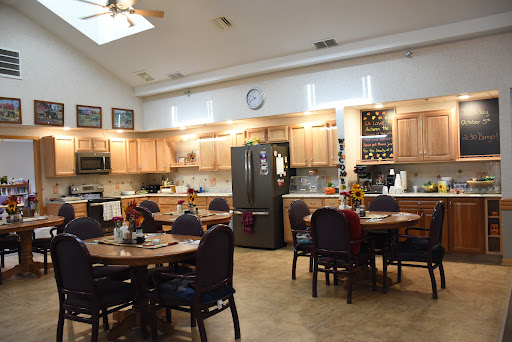 A spacious kitchen and dining area featuring wooden cabinets, modern appliances, and a welcoming atmosphere.