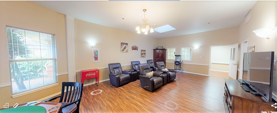 A cozy home theater room featuring comfortable recliners and ambient lighting.