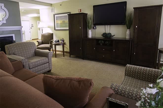 A cozy living room with comfortable seating and a large television.