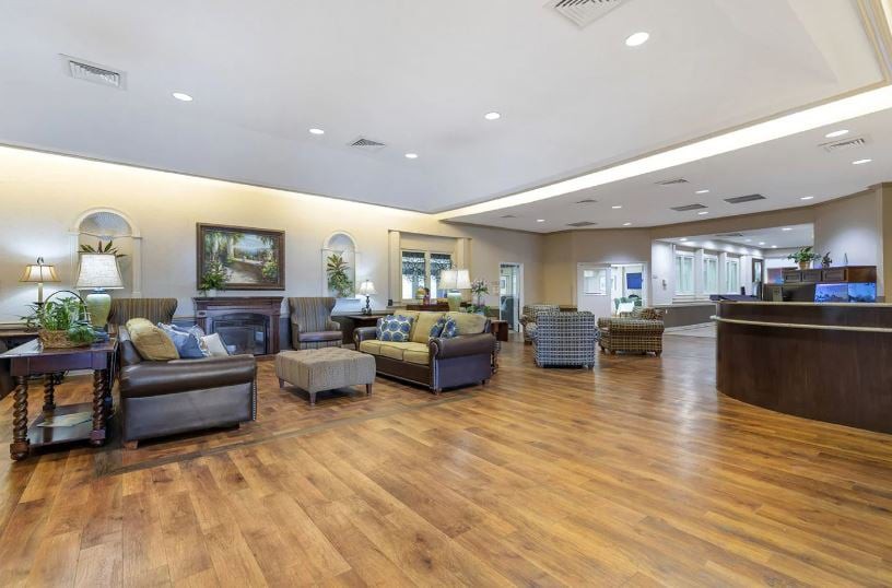 A spacious and modern lobby with comfortable seating and hardwood flooring.