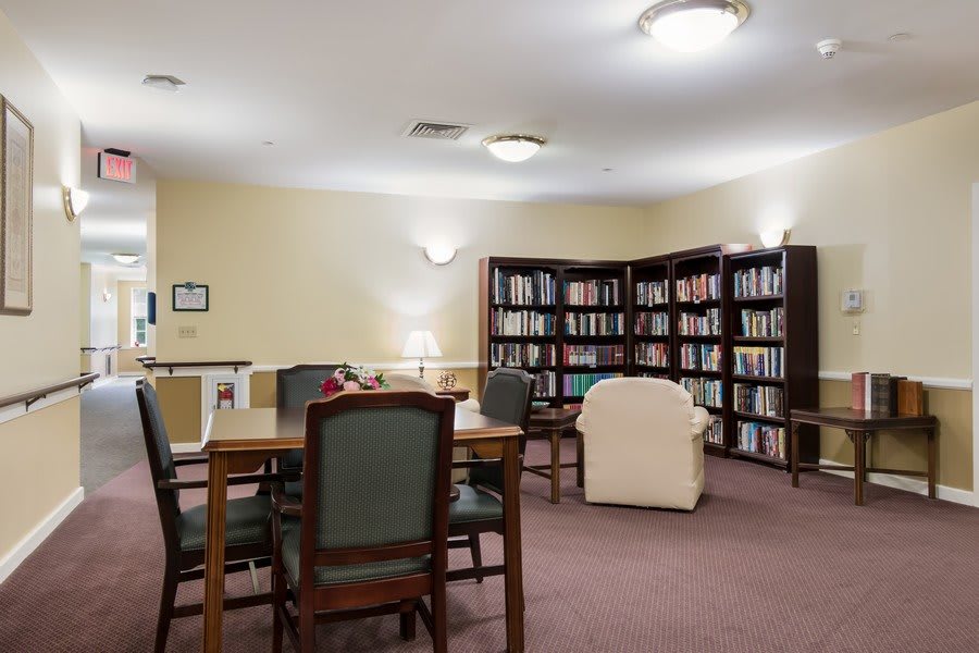 A quiet library reading room with bookshelves and seating areas.