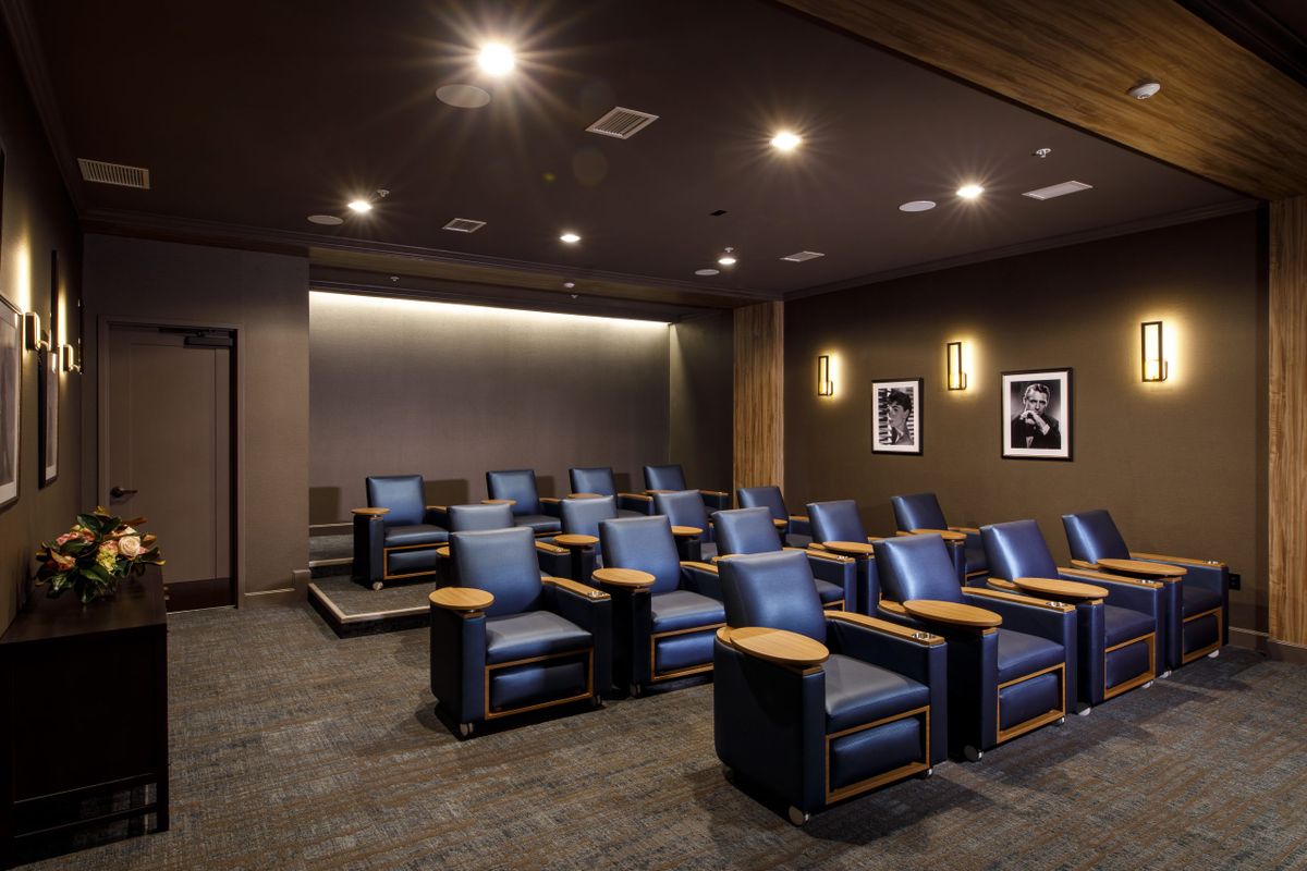 A modern home theater room with comfortable seating and ambient lighting.