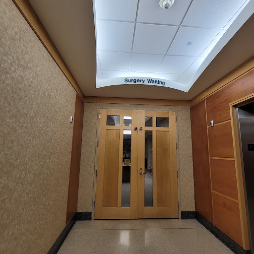 Entrance to a building with wooden doors and a lighted ceiling.