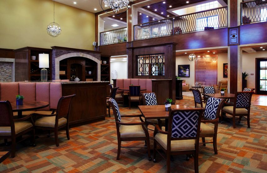 A modern lobby with a spacious seating area and elegant lighting fixtures.