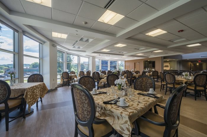 An elegantly decorated dining room with tables and chairs set up indoors.