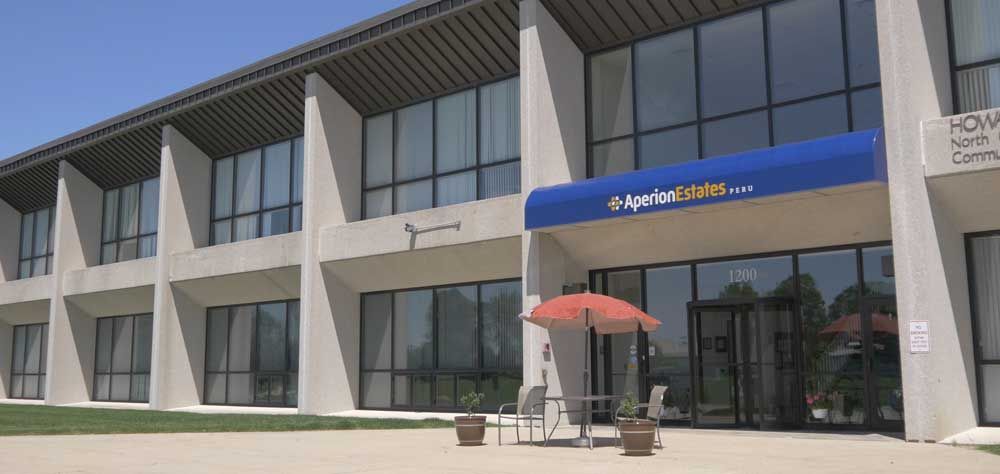 A real estate office with a modern design and outdoor seating area.