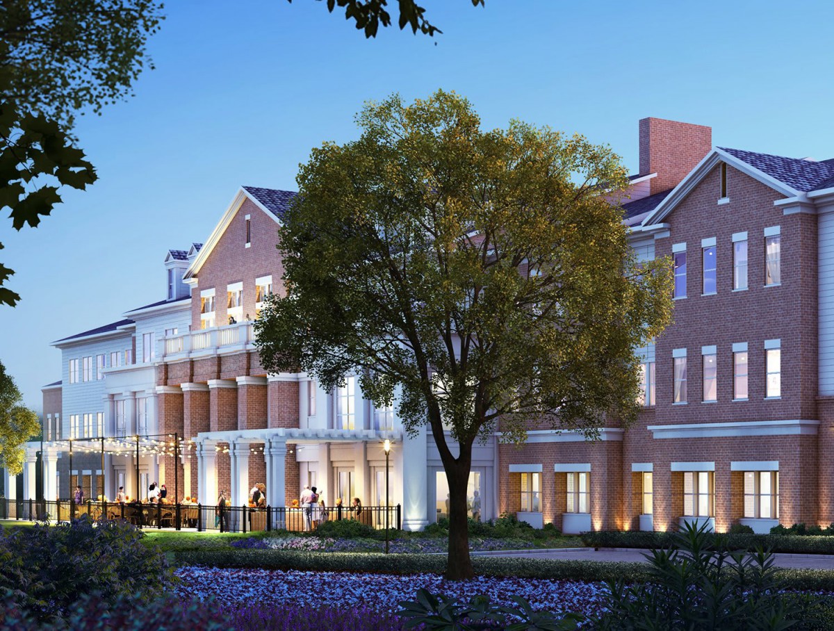 A beautifully lit building with a garden and tree in the evening.