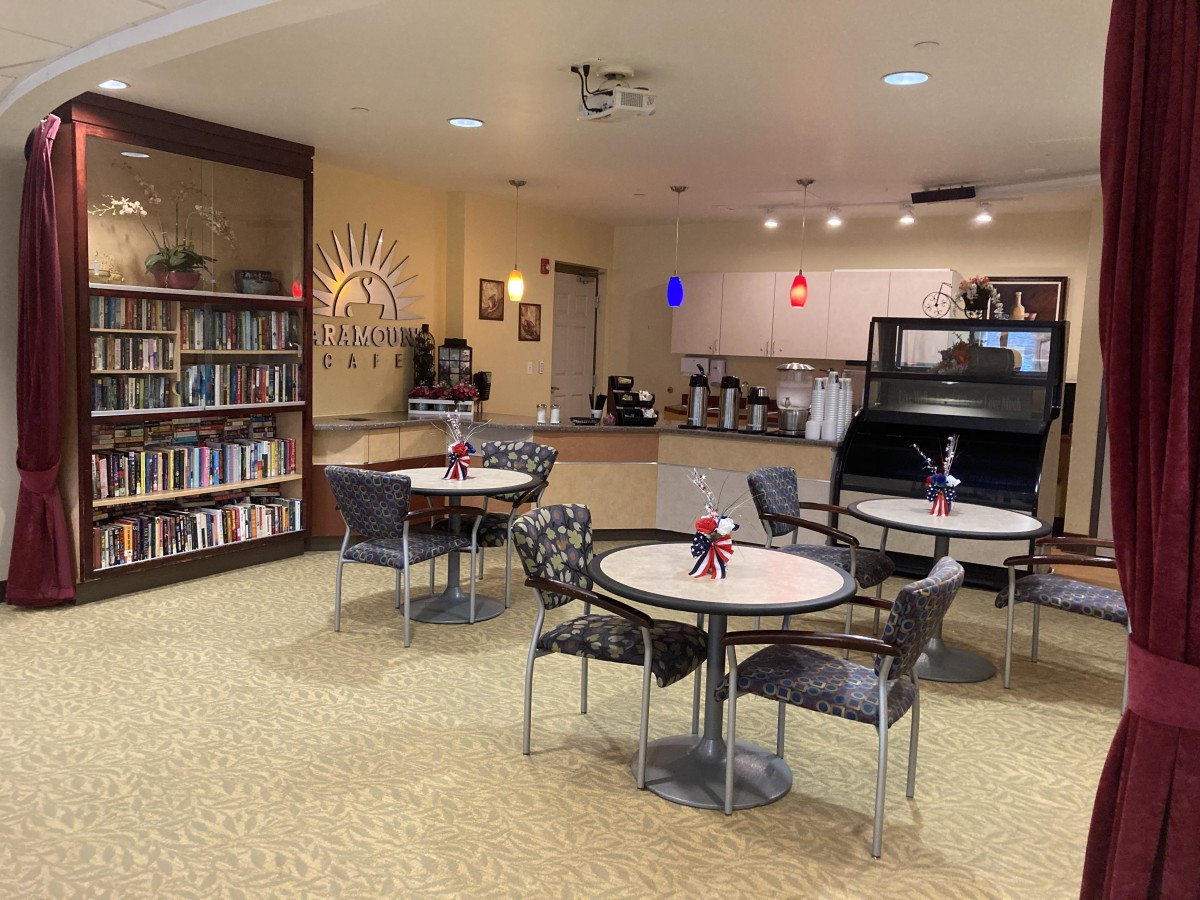 A cozy library cafe with bookshelves and tables for reading and enjoying coffee.