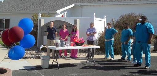 A group of healthcare professionals gathered outside, ready for a community event.