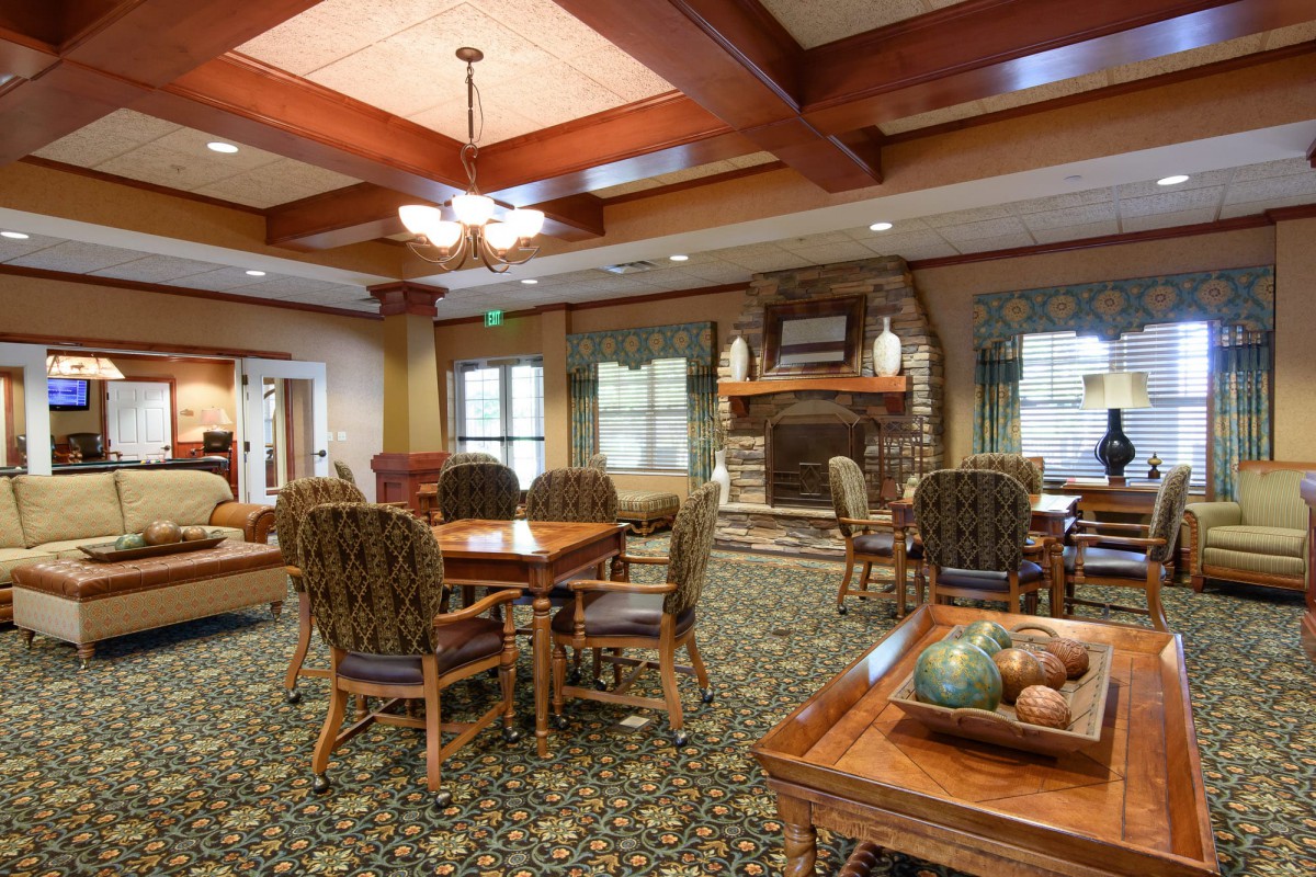 A cozy lounge area with comfortable seating and a fireplace.