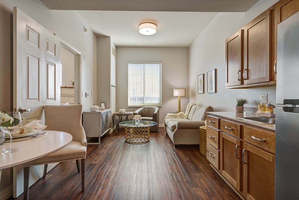 A modern and cozy living room with wood flooring and stylish furniture.