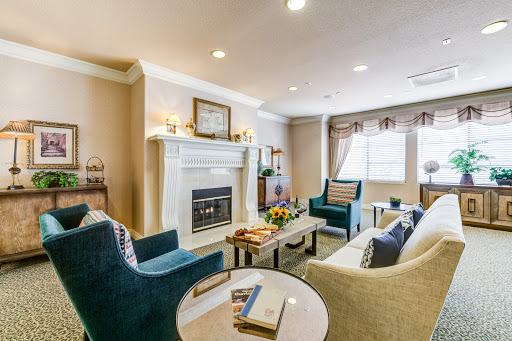 A cozy and elegantly designed living room featuring a fireplace, comfortable seating, and tasteful decor.