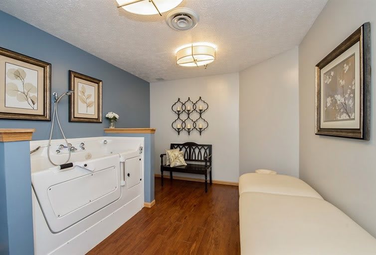 A modern interior seating area with a bench and decorative wall art.
