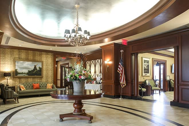A luxurious lobby with a chandelier, elegant furnishings, and tasteful decor.