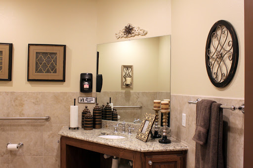 A beautifully organized bathroom vanity with a stylish mirror and decorative elements.