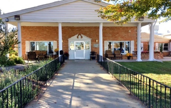 An outdoor area with landscaping, garden, and trees.