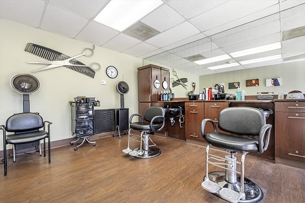 A well-organized barber shop with chairs and grooming equipment.