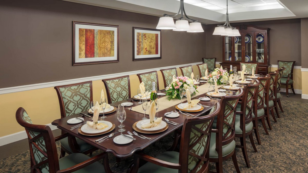 An elegantly set dining room table with decorative elements and soft lighting.