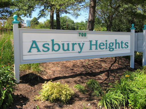 Entrance sign for Asbury Heights, surrounded by greenery.