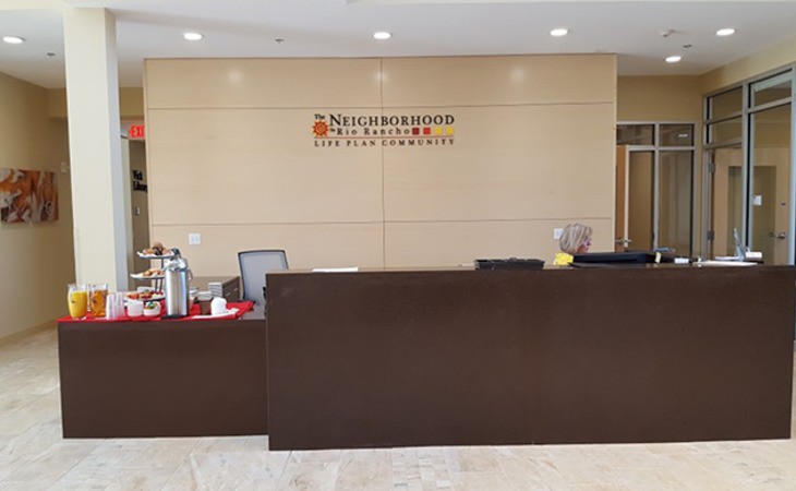A reception area with a desk in an office lobby.