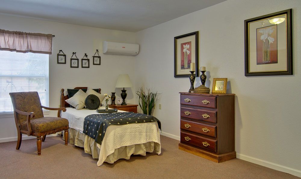 A cozy bedroom with a single bed, dresser, and decorative items on the walls.