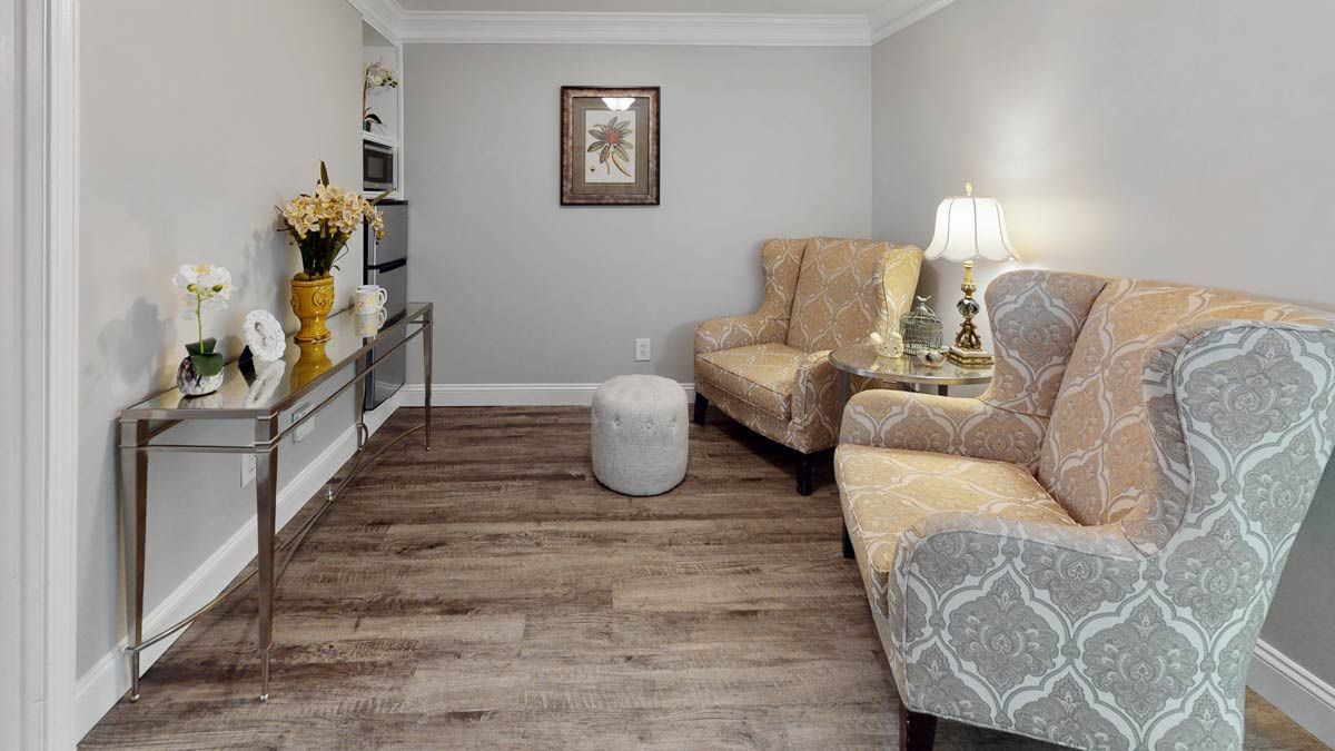 A cozy living room with armchairs and elegant decor.