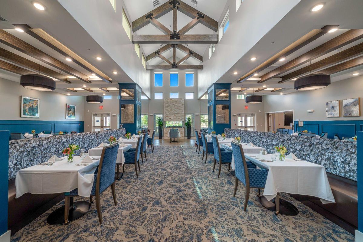 Spacious banquet hall set up with tables and chairs for an event.
