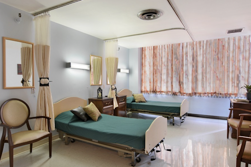 A well-lit hospital patient room featuring twin beds and modern decor.
