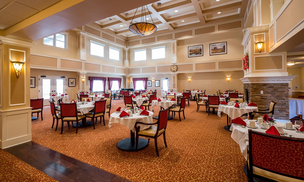 An elegant dining room with neatly arranged tables and chairs.