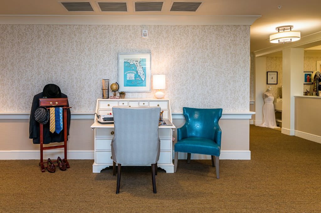 A well-decorated office space featuring a desk and two chairs.