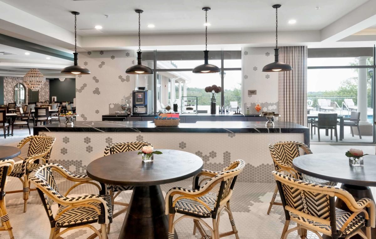 A modern cafe interior featuring stylish seating and unique pendant lighting.