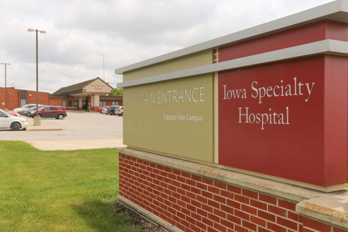 Exterior view of the Iowa Specialty Hospital with signage indicating the entrance.